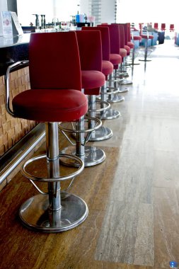 Bir uzun sayaç ve yüksek kırmızı sandalye bar Bar