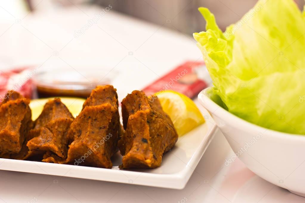 Traditional Turkish meal - ��ig kofte - hot spicy cutlets from c