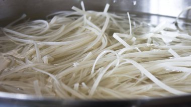 Pirinç Noodle büyük bir çelik tencerede. Asya mutfağı.