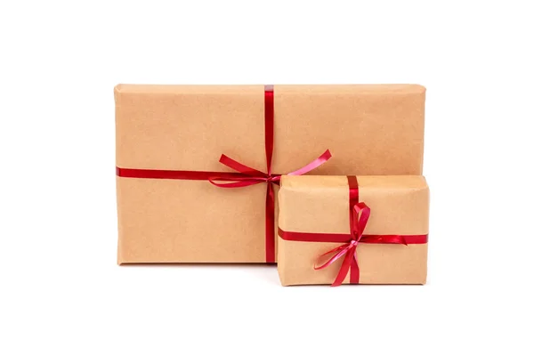 Gift Boxes in Craft Wrapping Paper with Red Ribbons isolated Stock