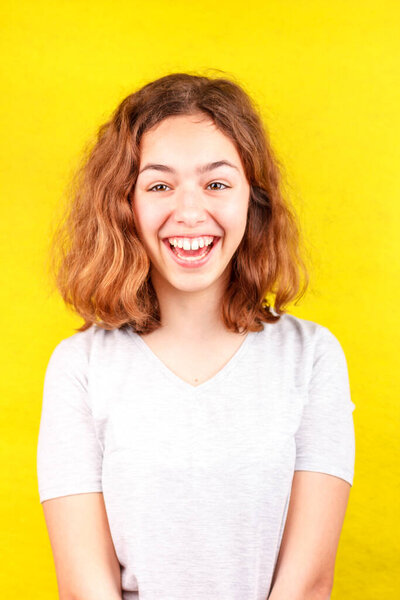 Portrait of funny curly teenager girl looking at camera