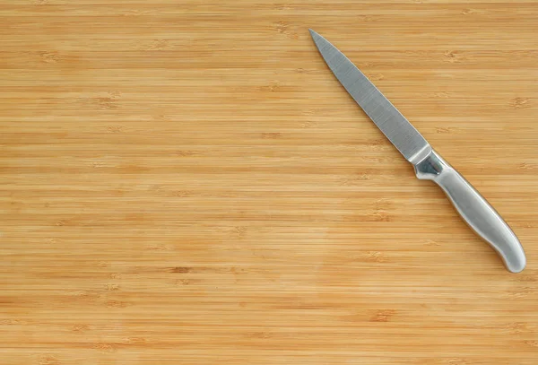 Steel kitchen knives on a wood board — Stock Photo, Image