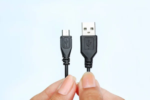 Hand holding usb to micro usb cable on white background — Stock Photo, Image