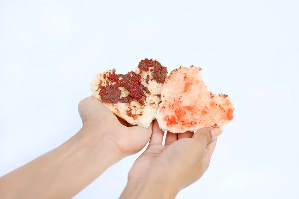 Hand holding open bite bread with shape of love on white background