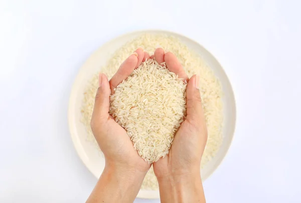 Beyaz pirinç yasemin beyaz arka planı beyaz plaka üzerinde tutan el — Stok fotoğraf