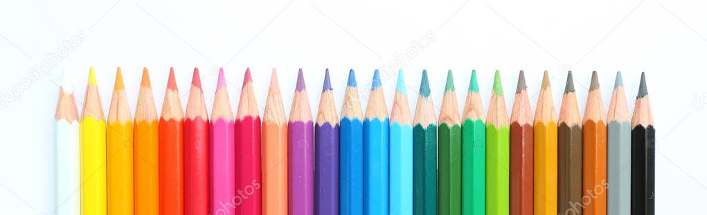 colored pencils row with wave on white background