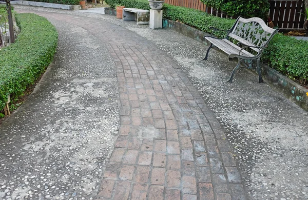 An old garden walkway constructed of bricks and mortar.