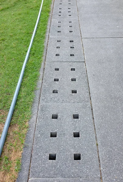 Cover of water drain on the road to collect raining water for sewage system — Stock Photo, Image