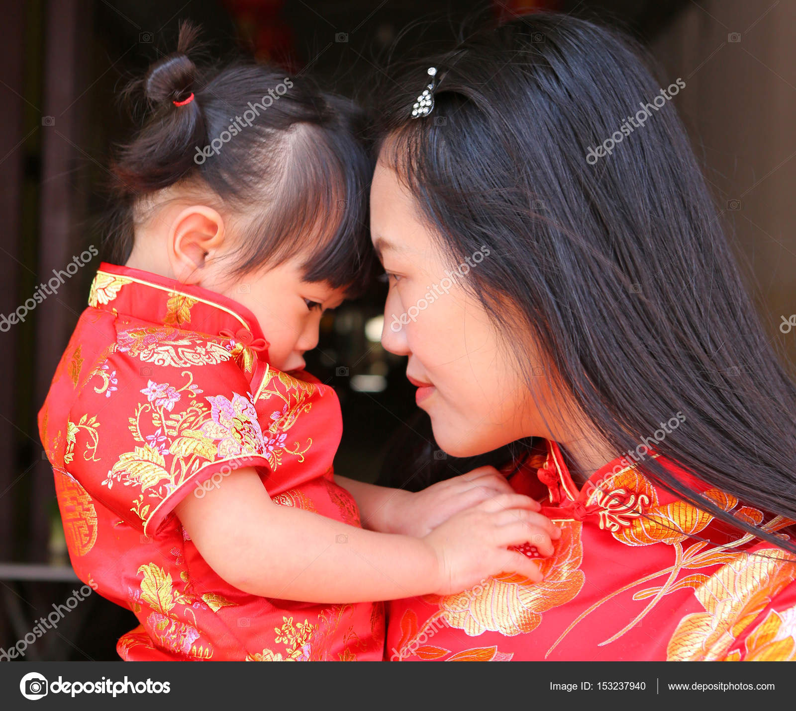 Happy Chinese New Year Cute Asian Girl Smile And Hug Her Child In