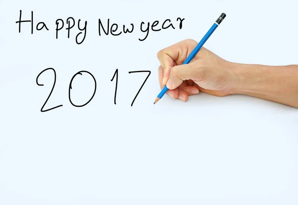 Käsi pitämällä lyijykynää valkoisella paperilla taustalla, kirjoittamalla kynällä sanalle "Hyvää uutta vuotta 2017  " — kuvapankkivalokuva