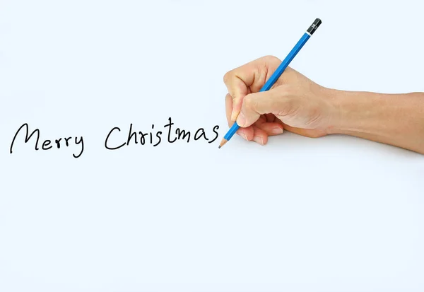 Hand holding a pencil on a white paper background, writing with pencil for word " Merry Christmas " — Stock Photo, Image