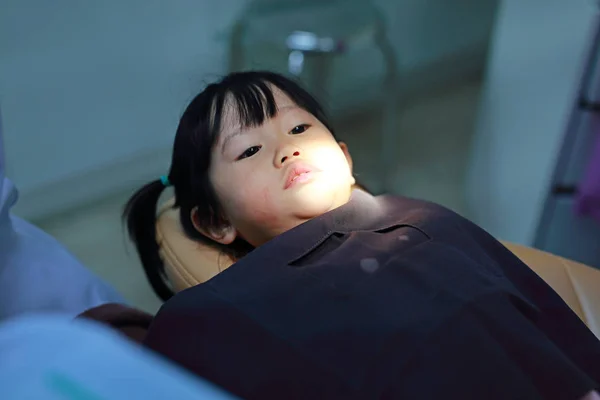 Little girl during dental extraction