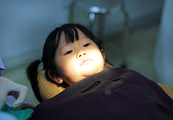 Little girl during dental extraction