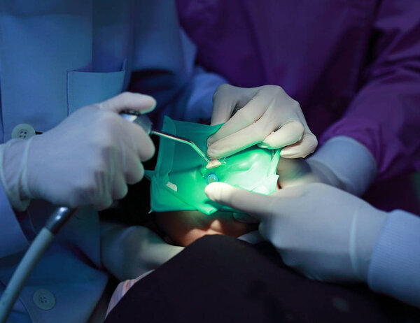 Little girl during dental extraction