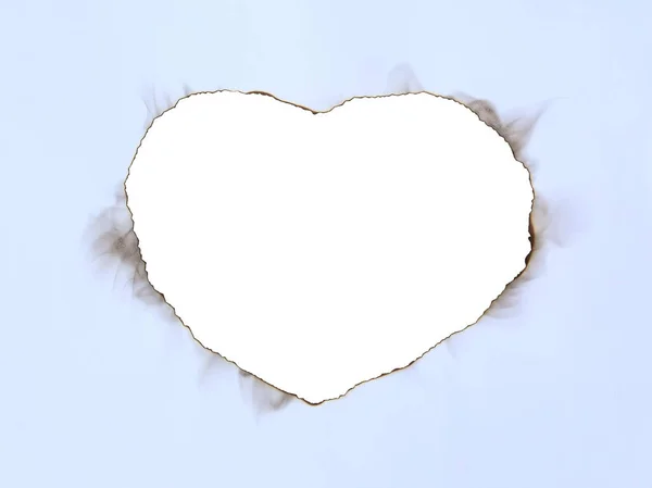 Paper sheet with Burning in shape of heart — Stock Photo, Image