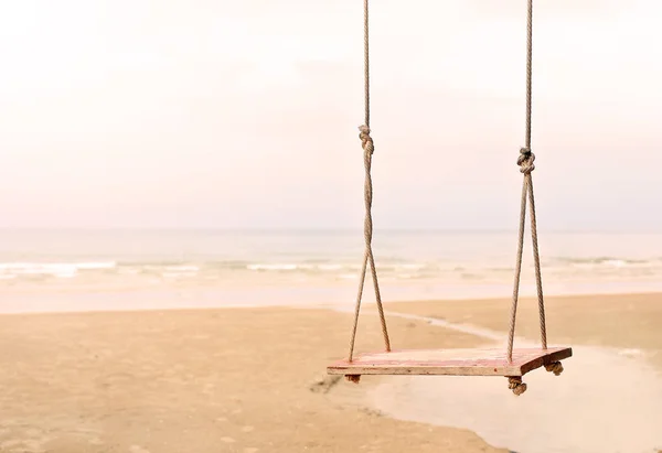 Lonely swing on the beach — Stock Photo, Image