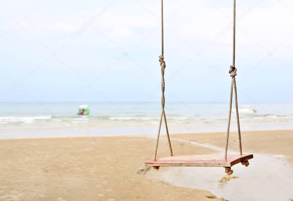 Lonely swing on the beach