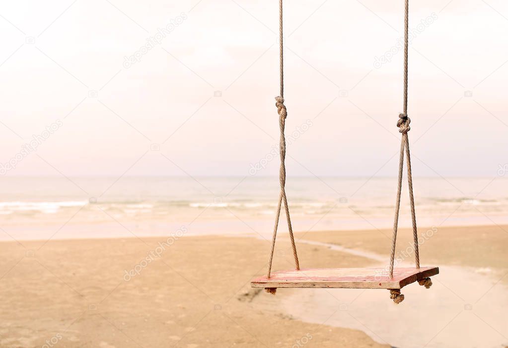 Lonely swing on the beach