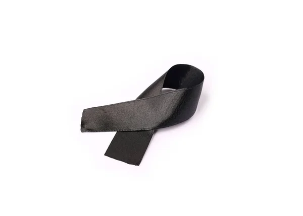 Zwart lint bow stof textuur, lint bewustzijn symbool van herinnering campagne of rouw over iemands dood, bidden voor wereld vrede concept — Stockfoto