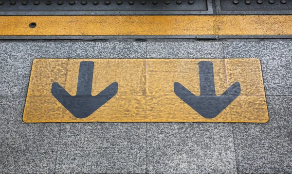 Seta sinal na estação de trem elétrico — Fotografia de Stock