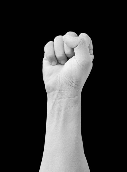 Punch fist of a man, Hand with clenched a fist isolated on black background, Black and white tone.