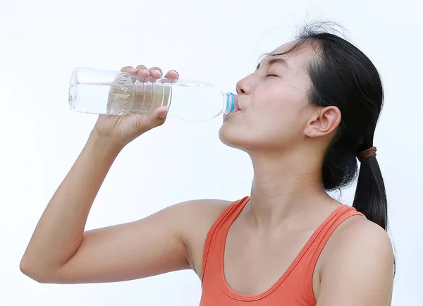 Femme saine buvant de l'eau après l'entraînement, Fitness Girl in Workout Concept sur fond blanc . — Photo