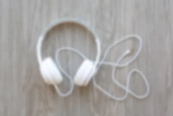 Blur image of headphones on wood — Stock Photo, Image