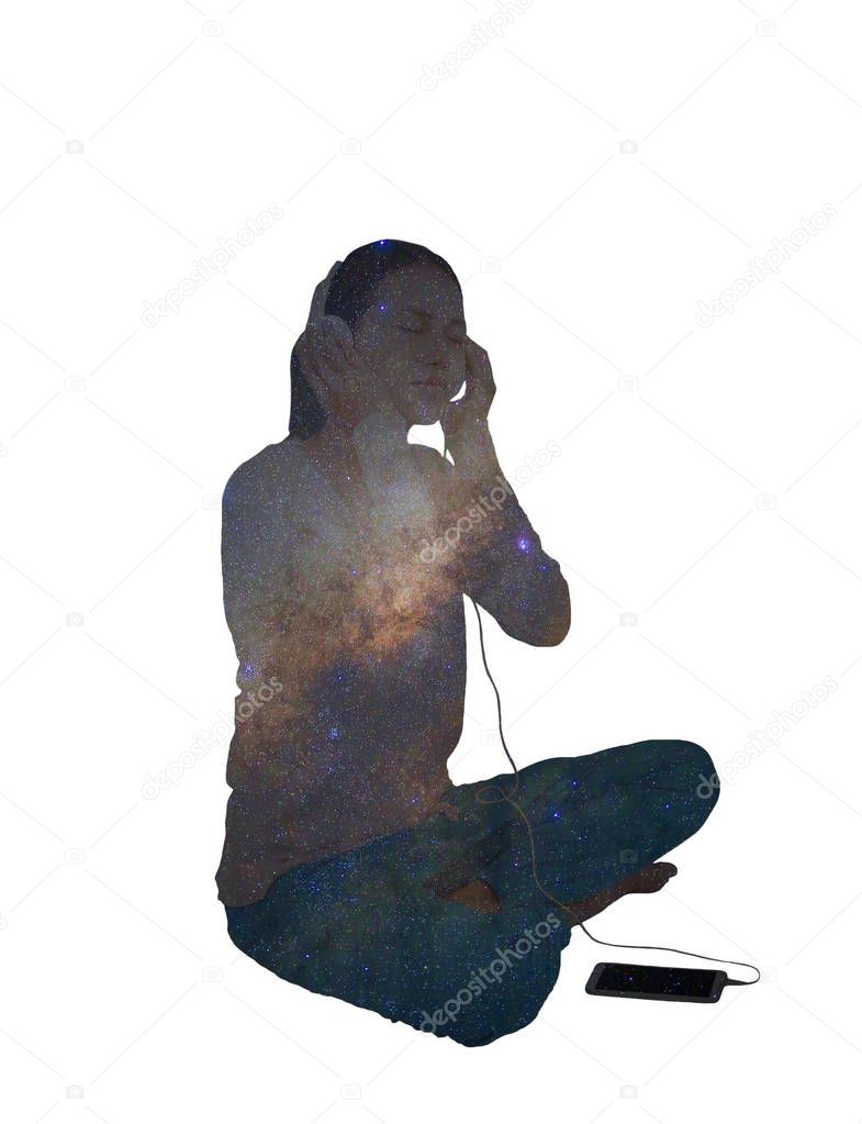Double exposure woman listening music in headphones with Universe space milky way galaxy