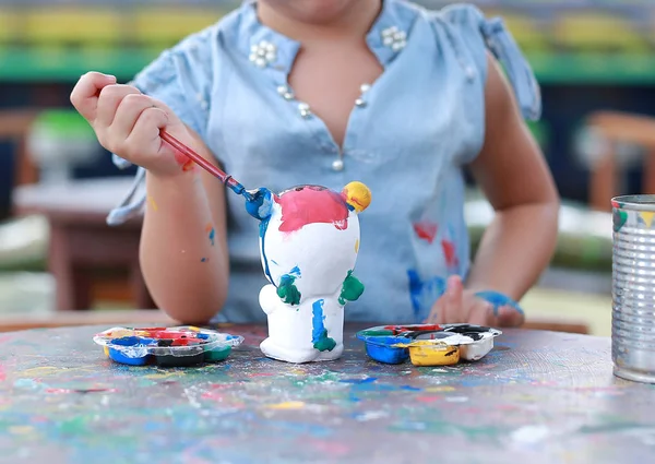 Child painting, Portrait little girl having fun to paint on stucco doll