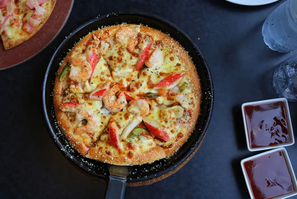 Delicious Seafood Pizza in tray on table