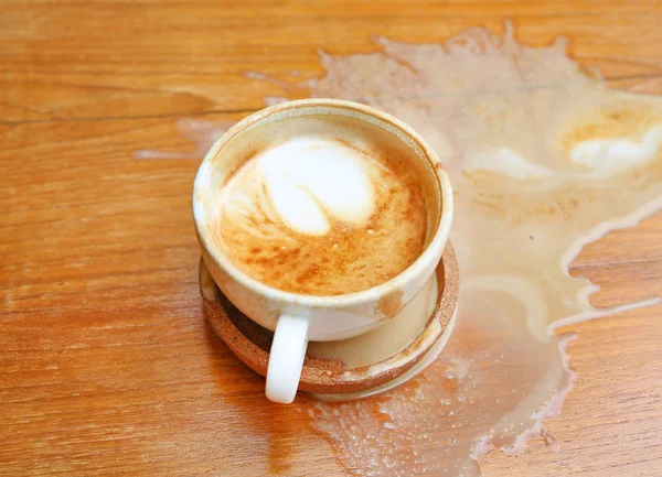 Coffee spilled on the wood table