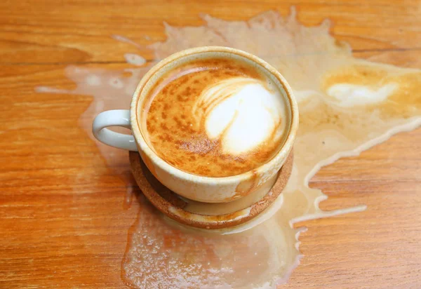 Coffee spilled on the wood table — Stock Photo, Image