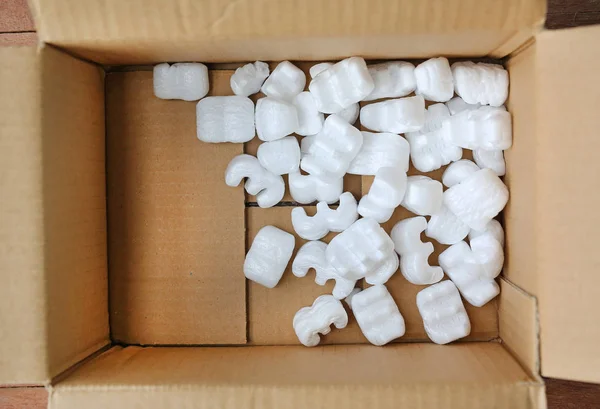 Protective white packaging peanuts that provides padding for the object being shipped — Stock Photo, Image