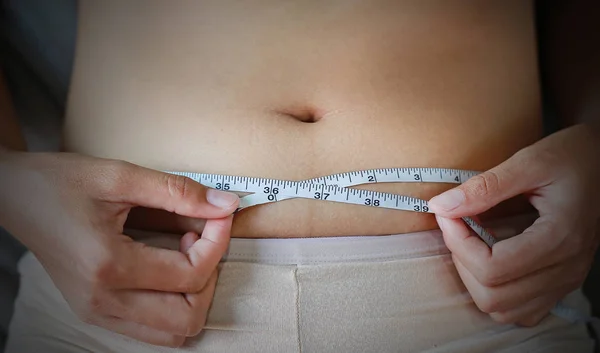 Woman body fat overweight. measure tape or line tape.