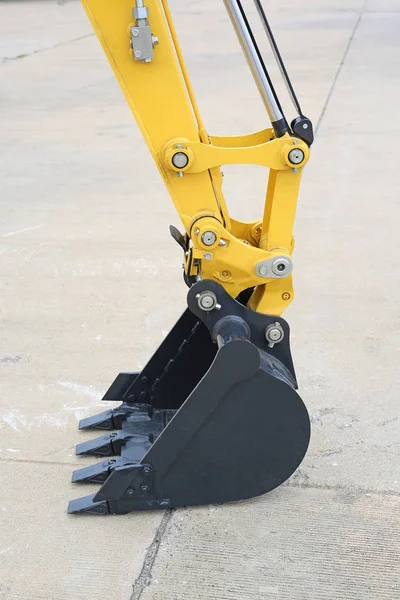 Excavator bucket on cement ground, Industrial excavator machine — Stock Photo, Image