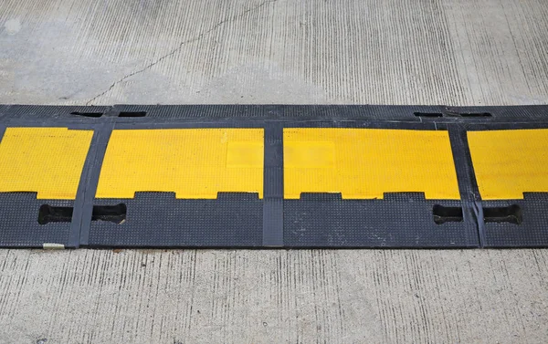 Traffic safety speed bump on an asphalt road — Stock Photo, Image