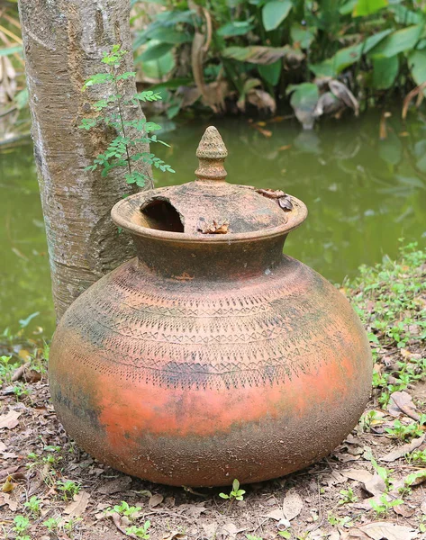 Old and broken clay jar in the garden