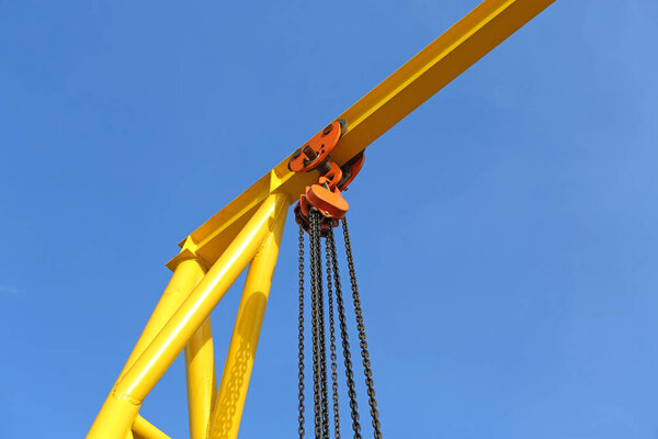 Crane for construction cradles against blue sky