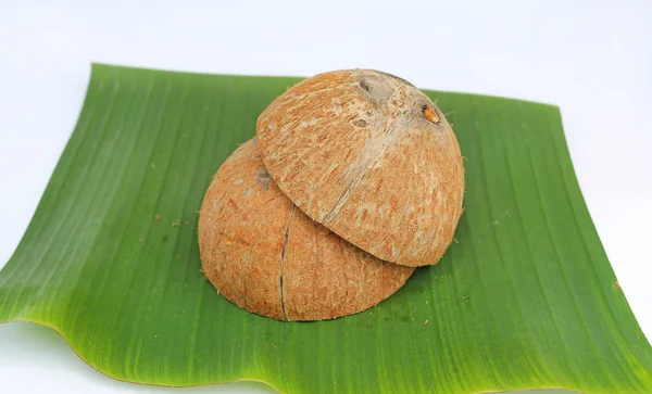 Coconut shell on banana leaf on white background — Stock Photo, Image