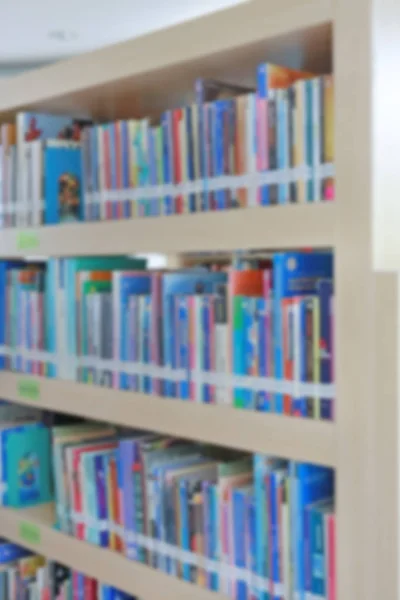 Blurred bookshelf in library, abstract blur defocused background