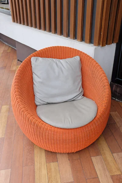 Orange rattan chair with pillow — Stock Photo, Image