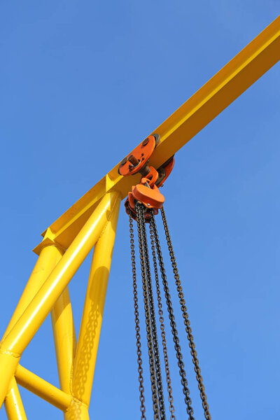 Crane for construction cradles against blue sky