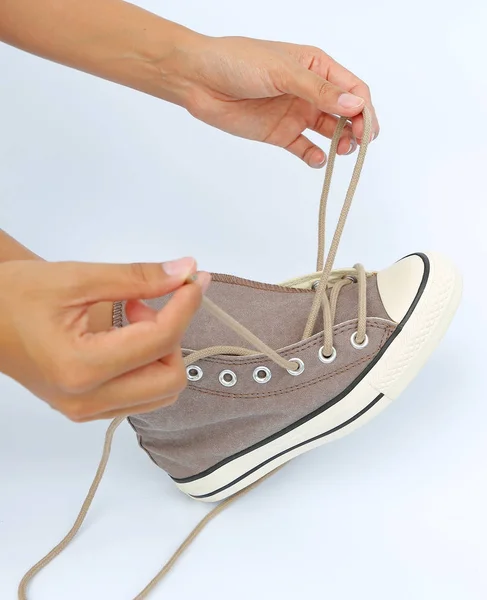 Close up tie her shoes canvas Sneakers on white background