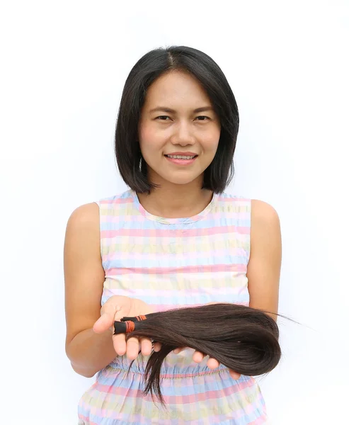 Ασιατικές γυναίκα δωρίζοντας τα μαλλιά της σε ασθενείς με καρκίνο - κρατώντας τα μαλλιά της πρώην μετά από ένα κούρεμα, γενναιόδωρα προσφέροντας αφιλοκερδώς μακριά μαλλιά για να καταστεί περούκες για τους ασθενείς με καρκίνο που έχασαν τα μαλλιά τους — Φωτογραφία Αρχείου