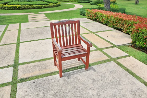 A velha cadeira de madeira marrom vermelho sozinho no parque — Fotografia de Stock