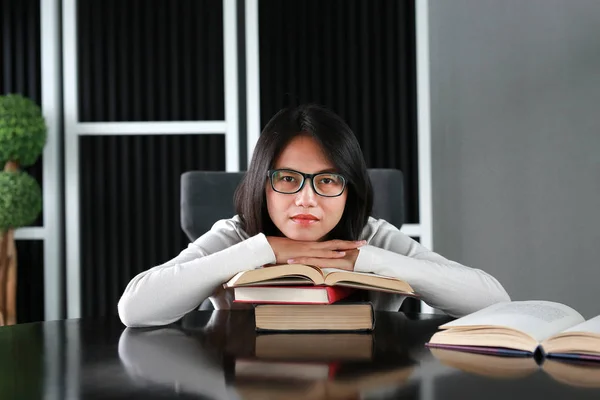 Asian woman relax and lying in the library.