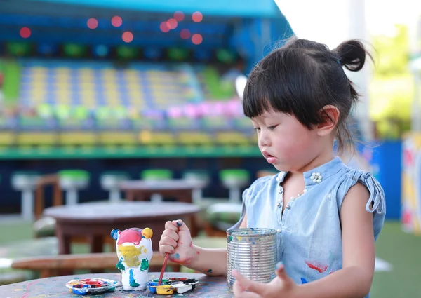 Pintura infantil, Retrato niña divirtiéndose para pintar en estuco muñeca — Foto de Stock