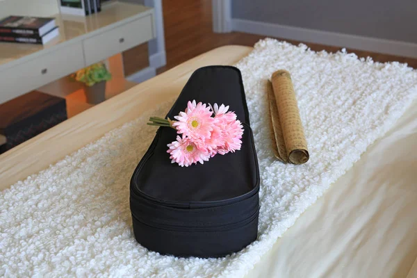 Violin Case and artificial flower on the bedroom