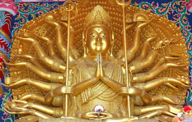 Golden Guanyin Buddha statue with thousand hands in Thailand clipart