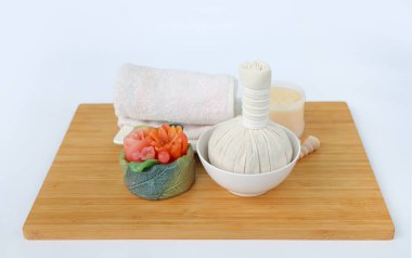 Havlu ve Salt Scrub, Spa konsept Bambu tahta karşı beyaz arka plan üzerinde topla sıkıştırma spa bitkisel